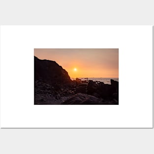 Orange Sunset Over A Rocky Beach Posters and Art